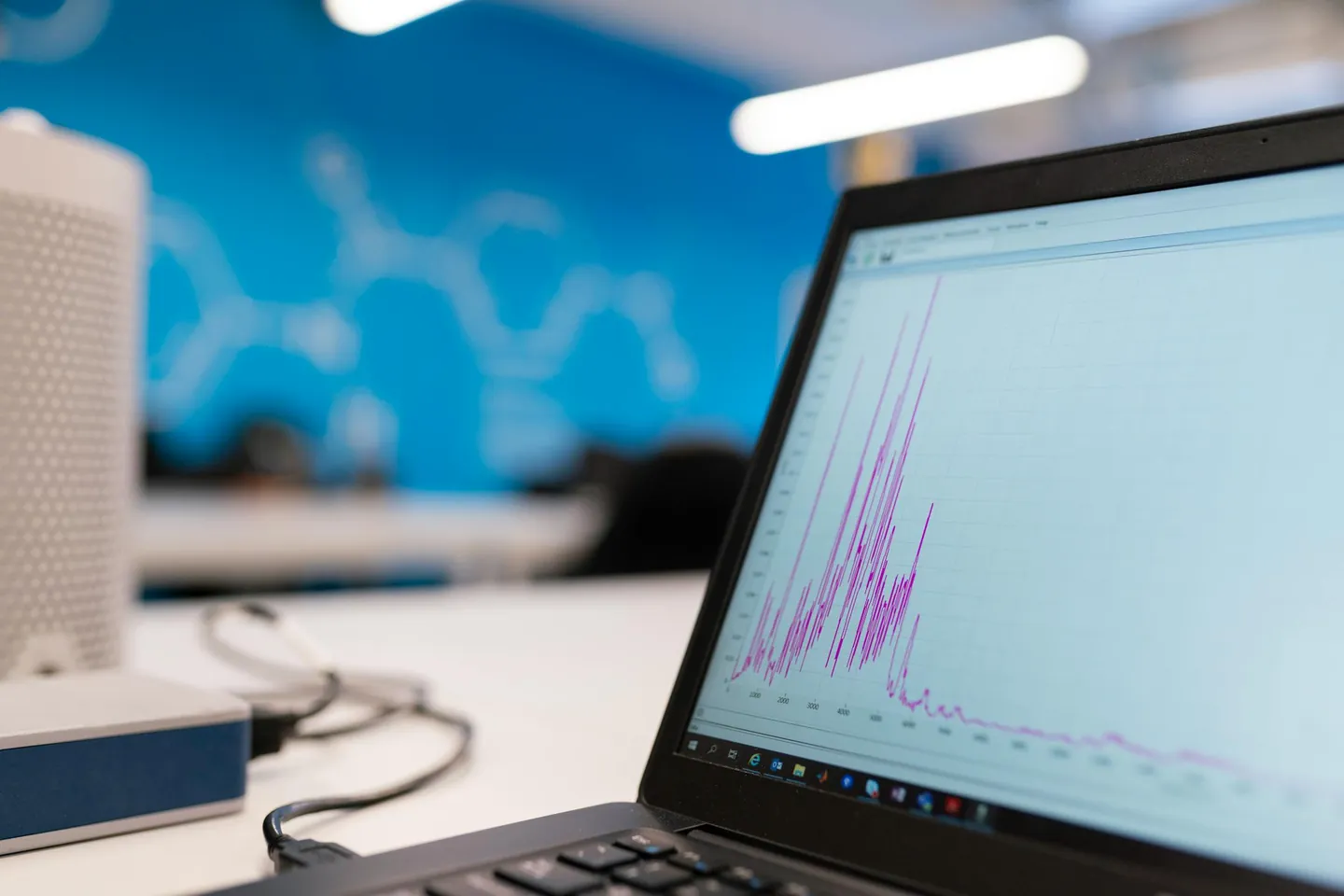 Laptop showing performance analytics in a modern workspace
