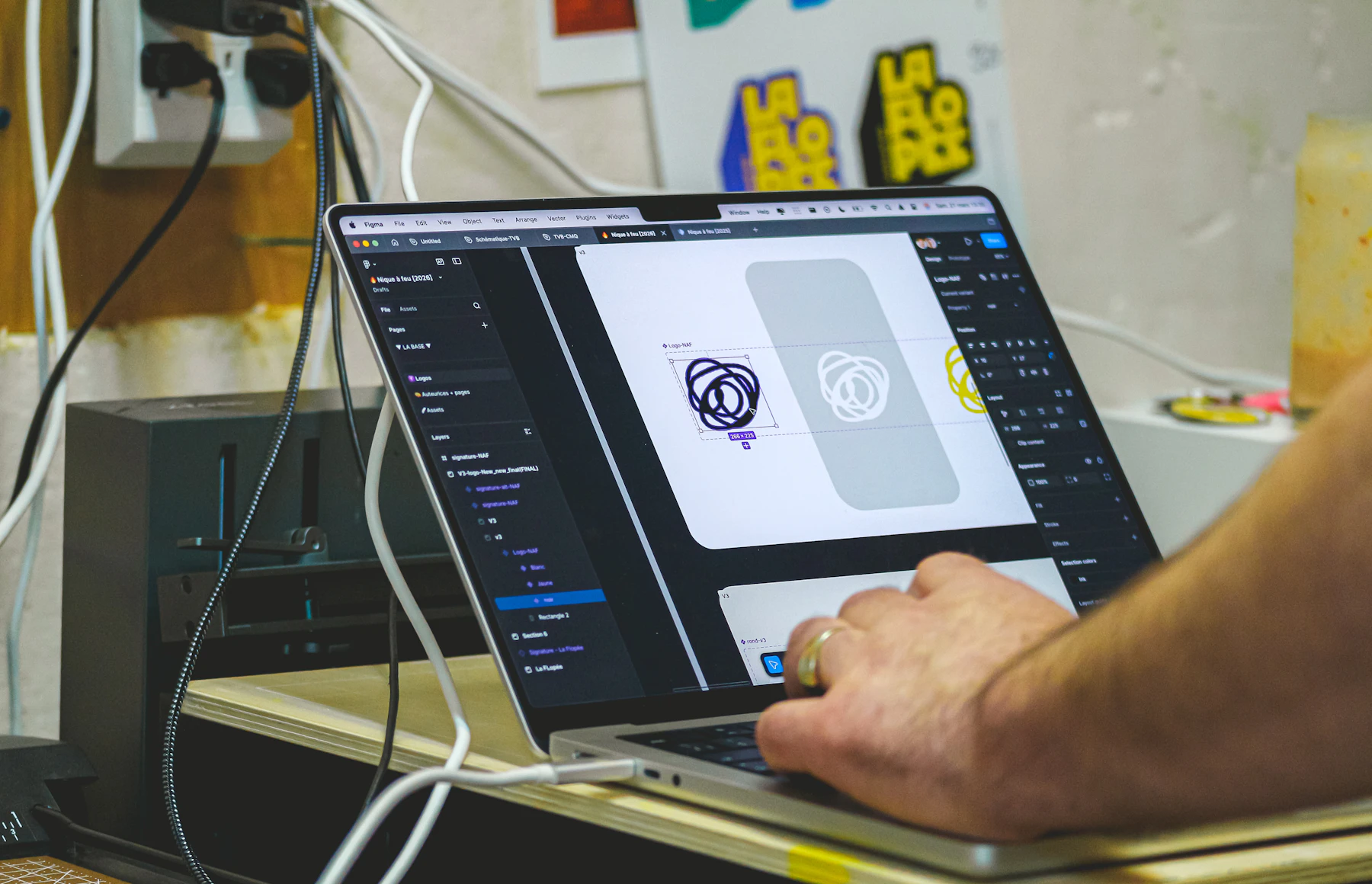 Designer refining a premium website interface on a laptop